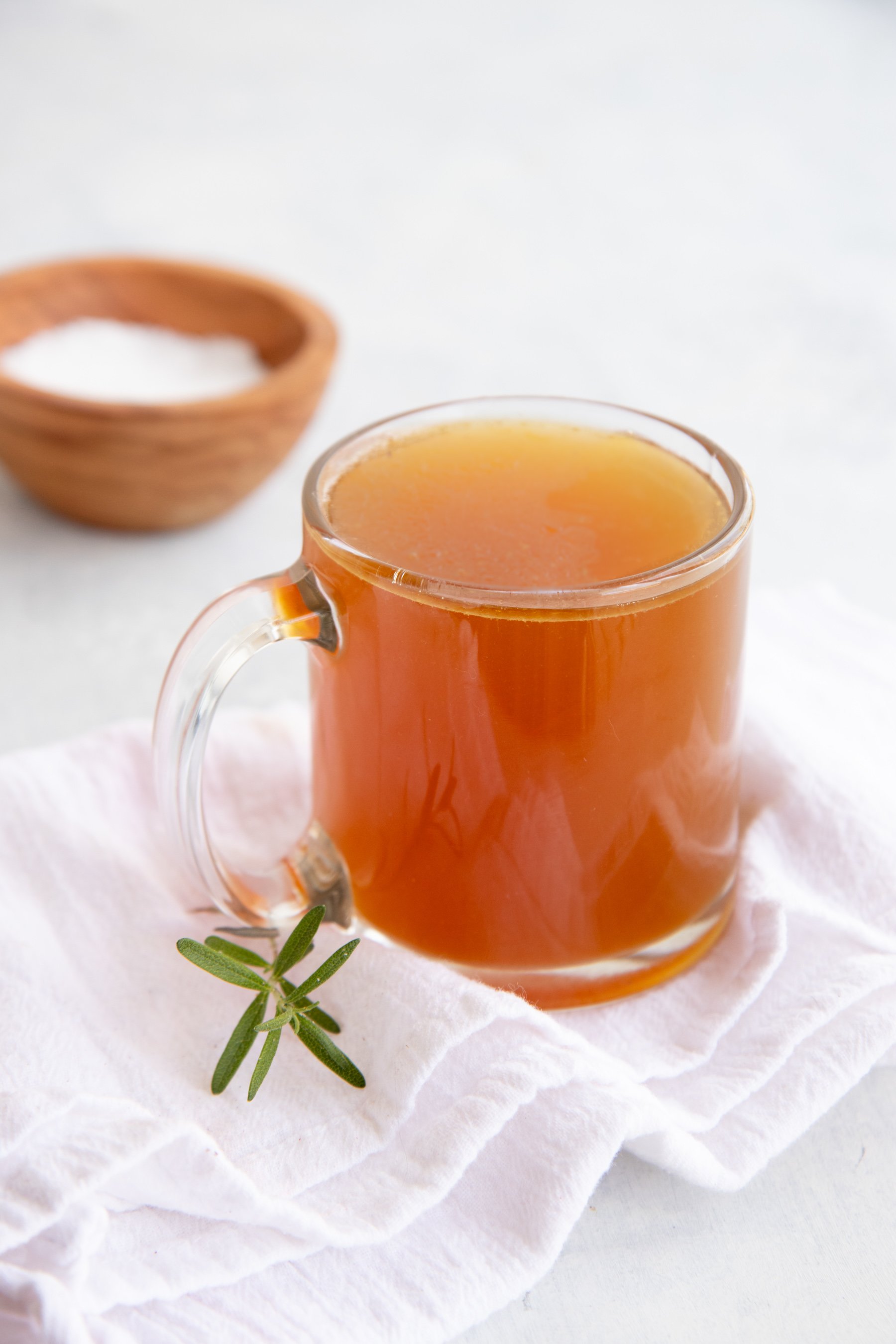 Side angle shot of bone broth in a clear glass mug