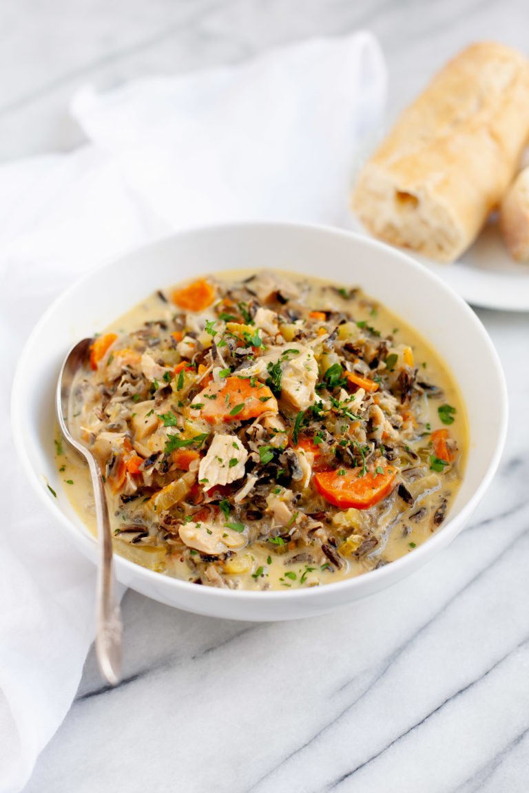 Cream of Turkey and Wild Rice Soup in a white bowl with a spoon