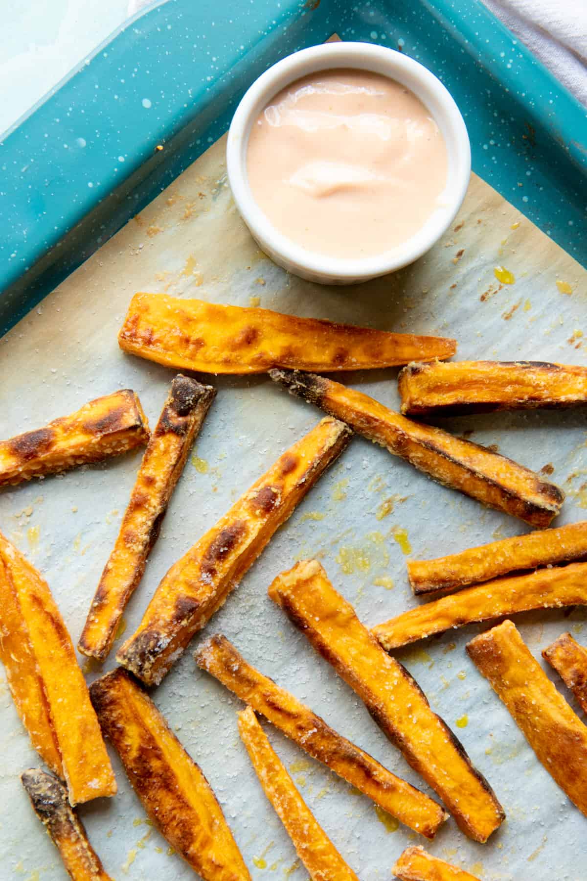 Crispy sweet potato fries on a baking sheet.