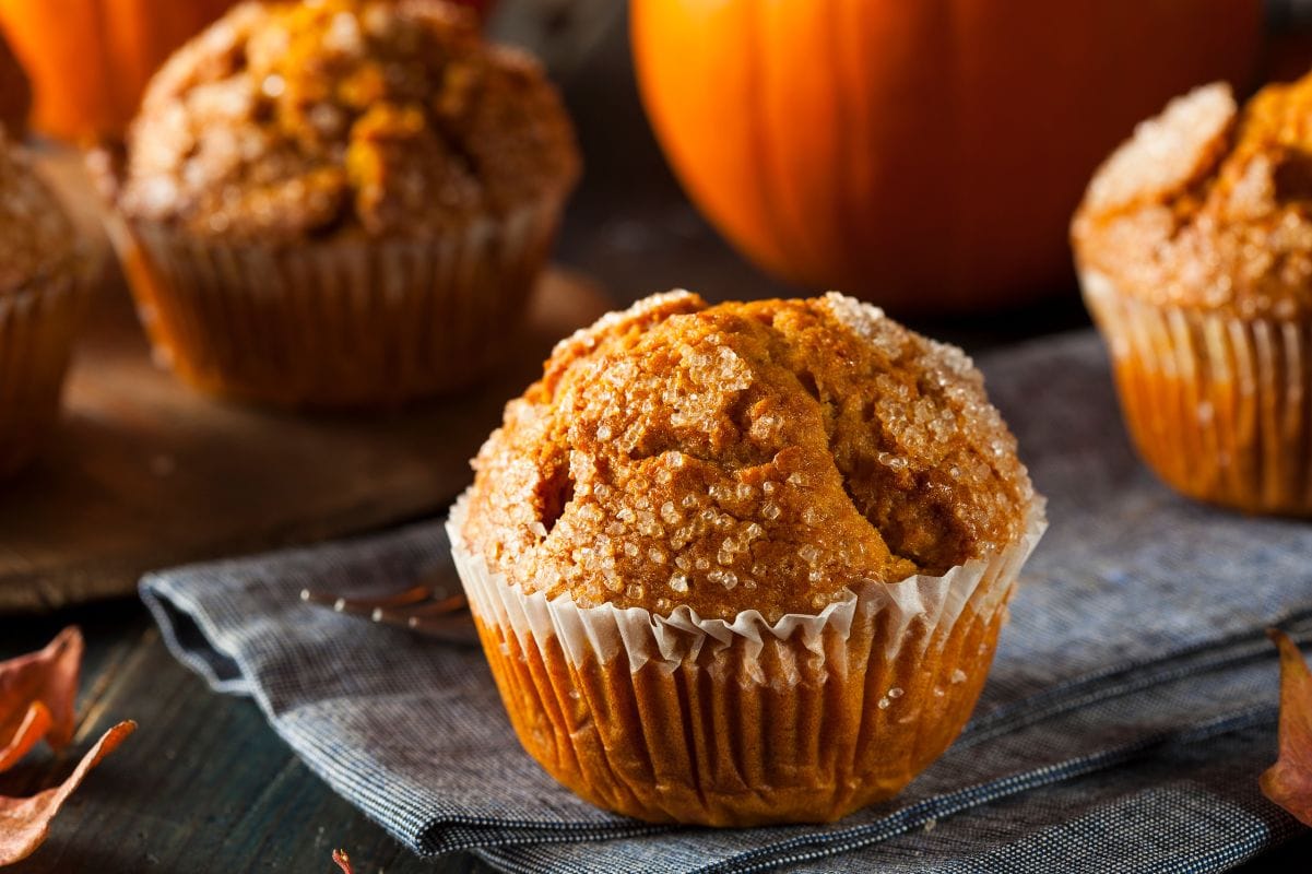 Close view of the crunchy sugar top on a perfectly domed bakery-style muffin.