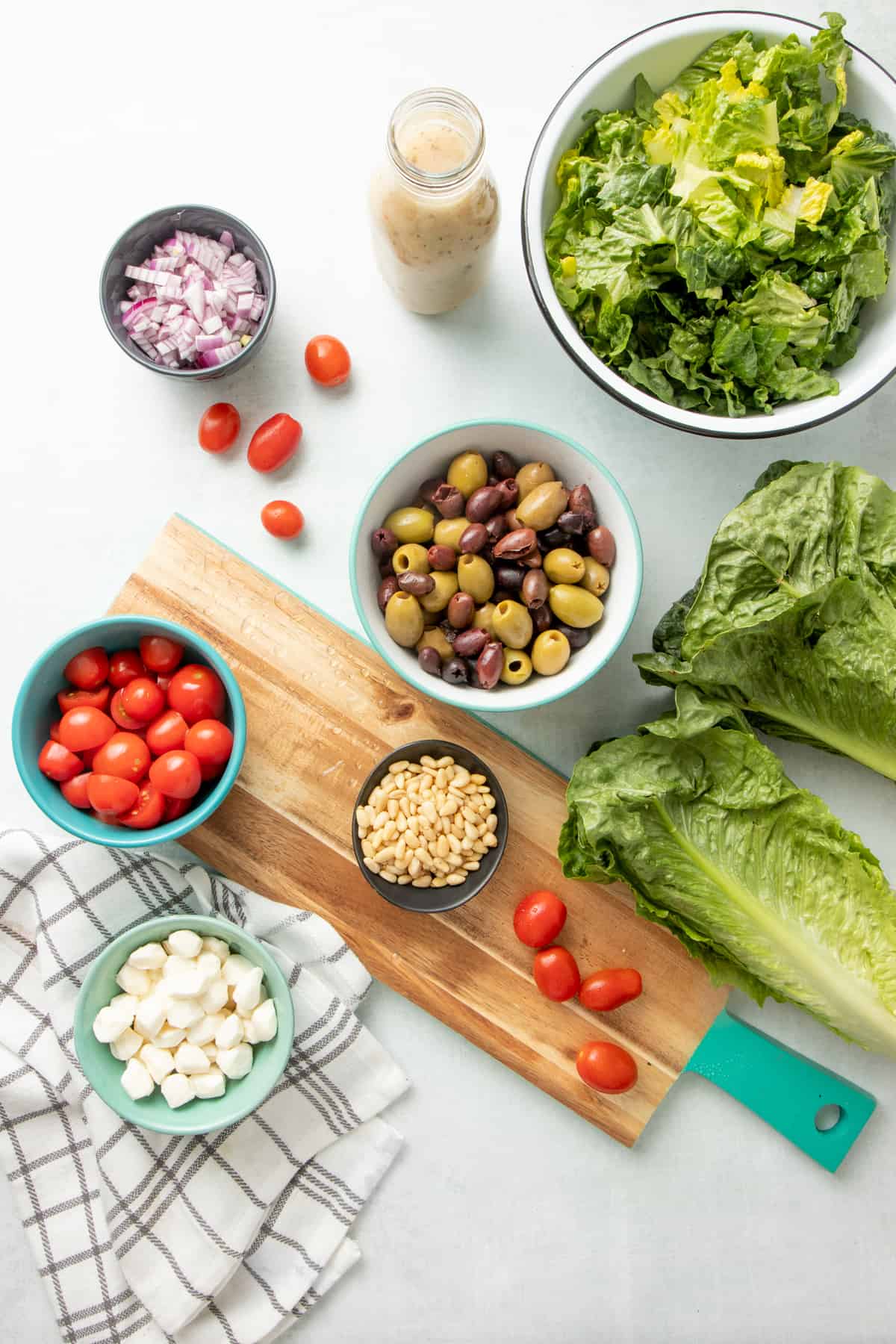 Ingredients for Italian chopped salad arranged in individual bowls.