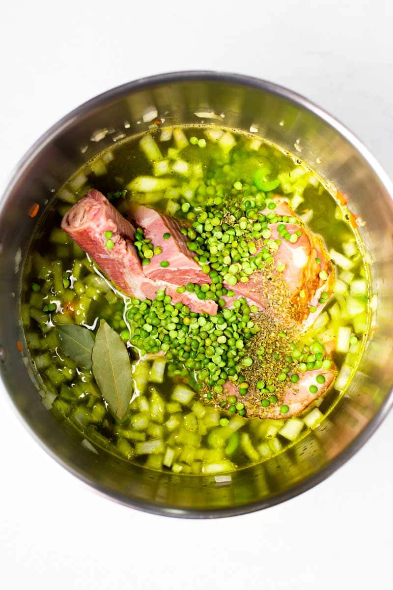 Overhead of all the ingredients for  soup in a large pot.