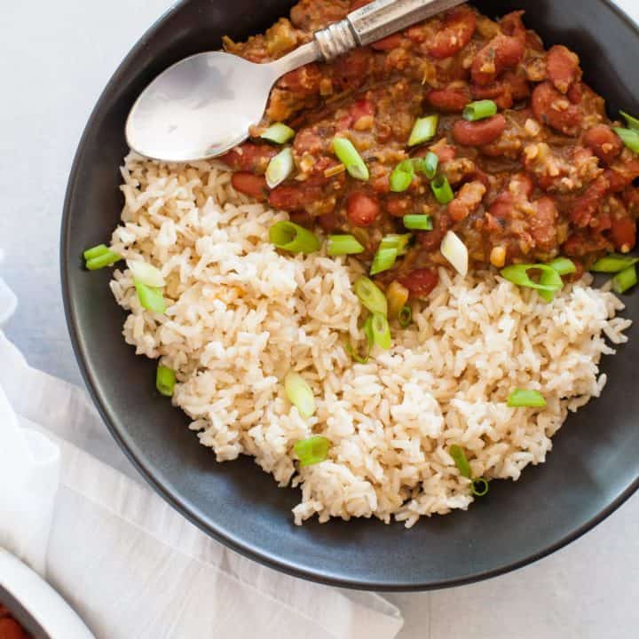 Gray bowl full of Vegan Red Beans and Rice with a spoon