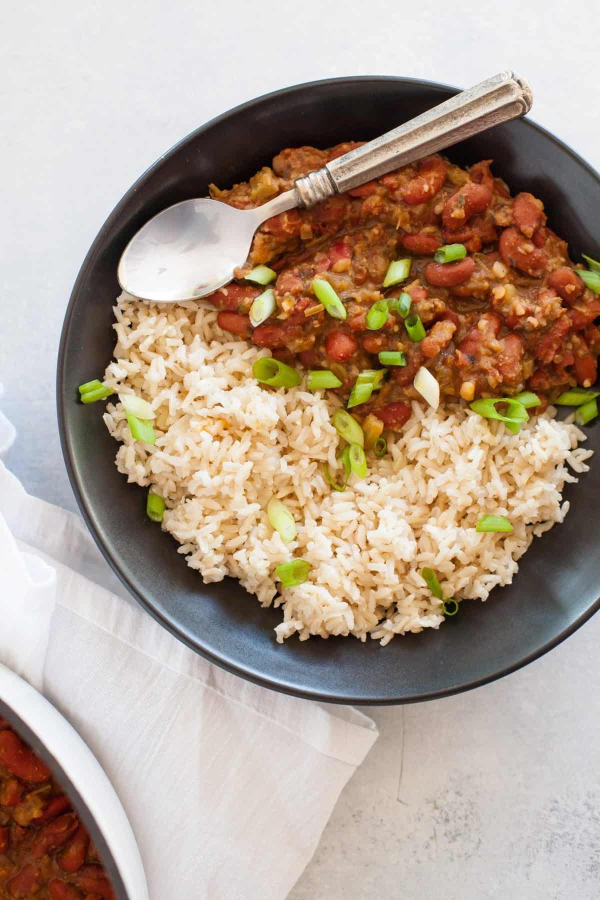 Gray bowl full of Vegan Red Beans and Rice with a spoon