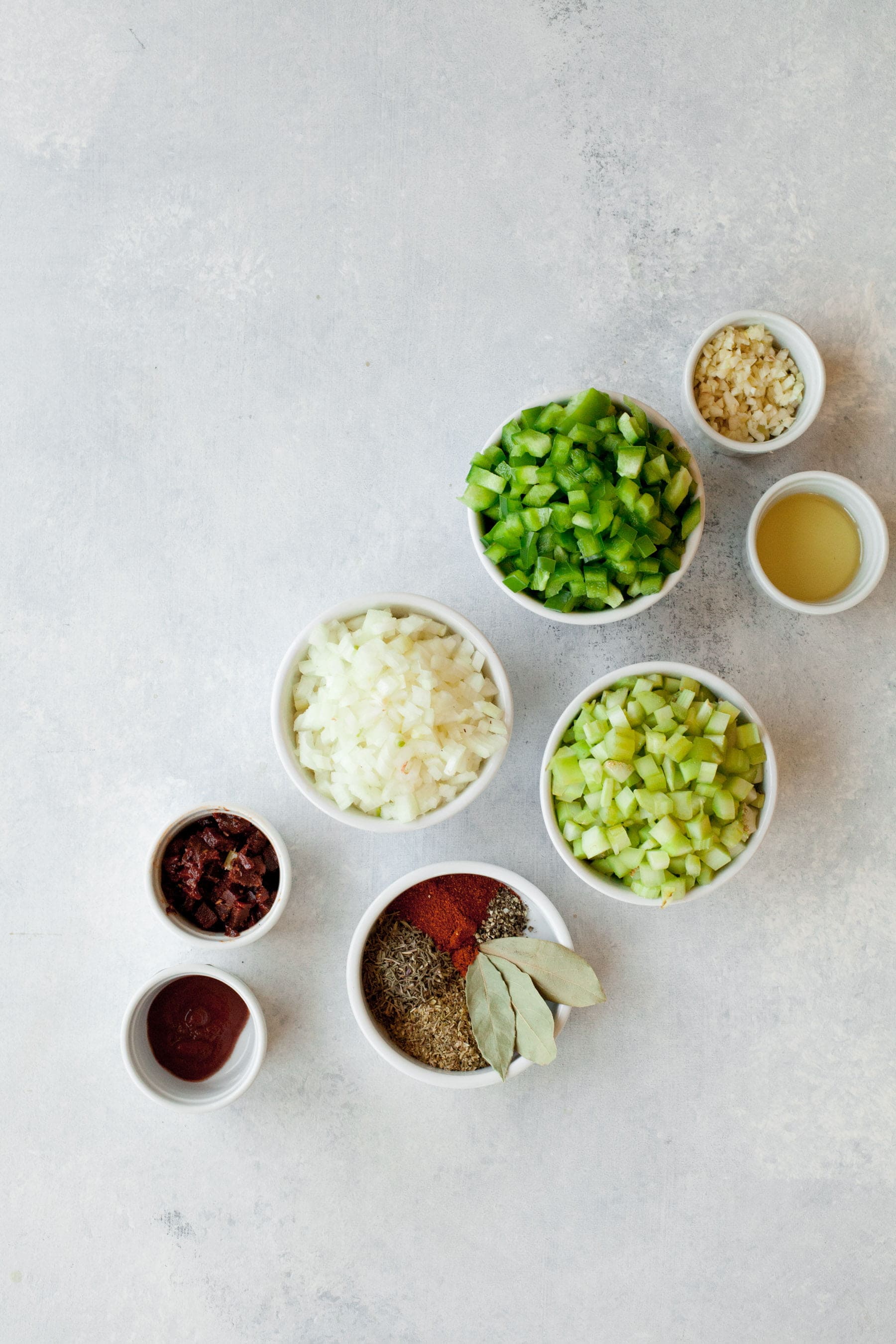 Ingredients for a Vegan Red Beans and Rice recipe in individual bowls