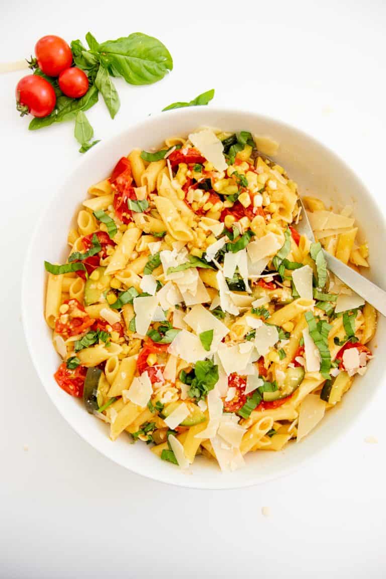 Overhead shot of a white bowl filled with Summer Roasted Vegetable Pasta.