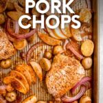 Overhead of pork chop dinner in a baking pan with seasoned chops, potatoes, and apple slices. A text overlay reads, "Sheet Pan Pork Chops."