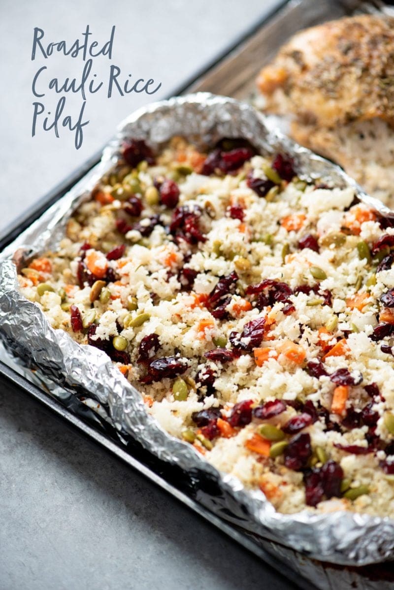 Cauliflower rice pilaf in aluminum foil. A text overlay reads "roasted cauli rice pilaf."