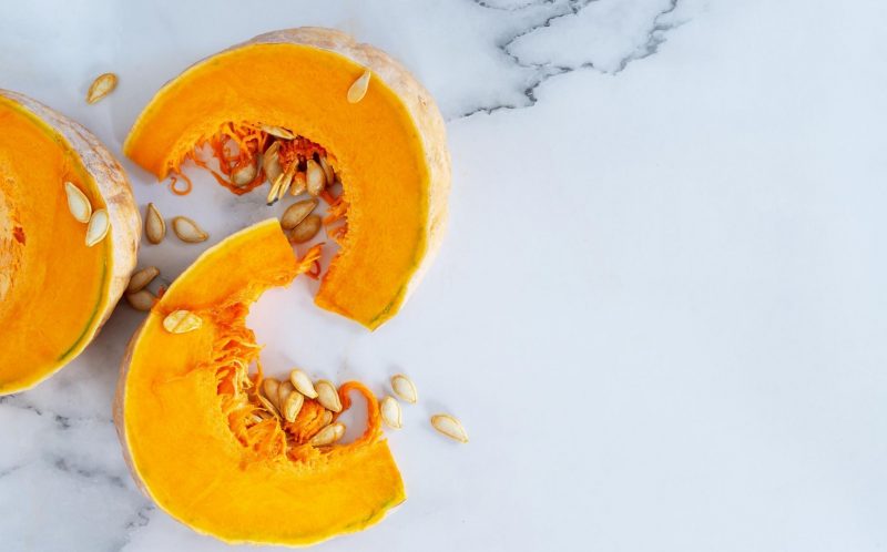 Wedges of pumpkin on a marbled background.