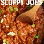 A wooden spoon stirs filling for Sloppy Joes in a cast iron skillet. A text overlay reads "No Sugar Added Sloppy Joes. Paleo & Whole30-Friendly."