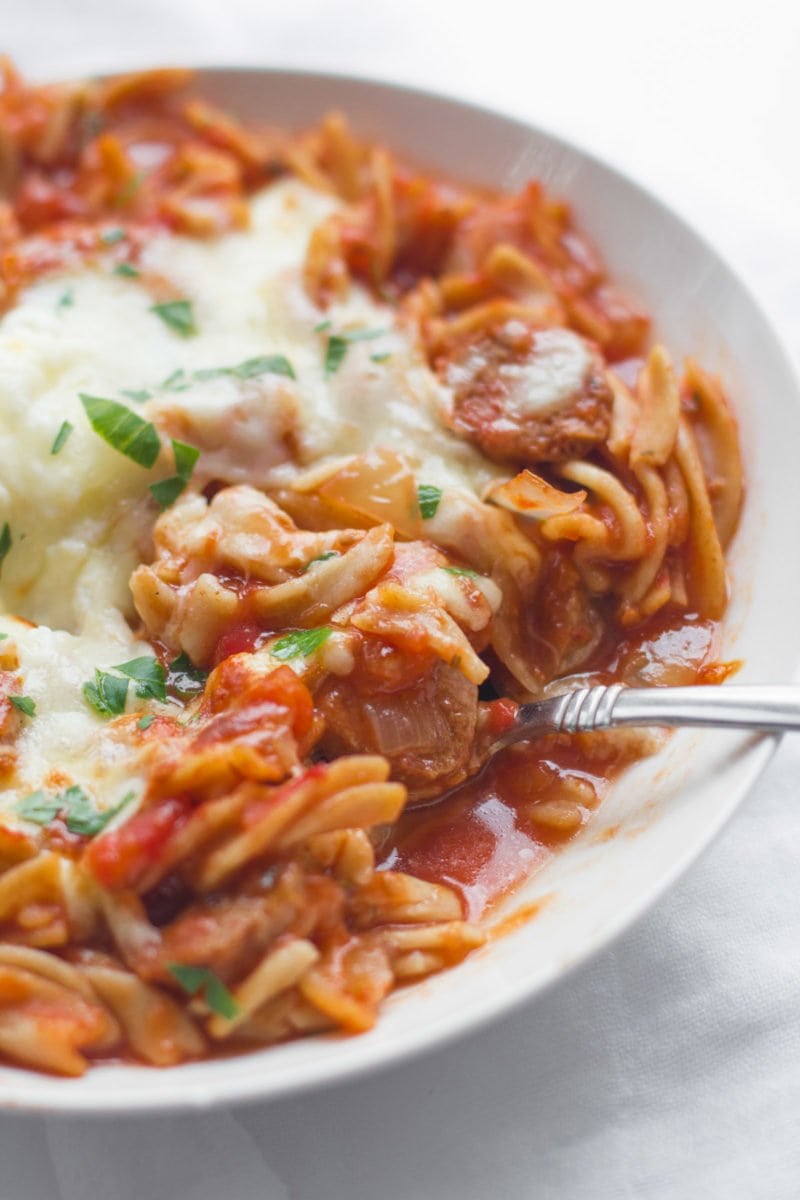 A bowl of Slow Cooker Lasagna Soup sits on a table.