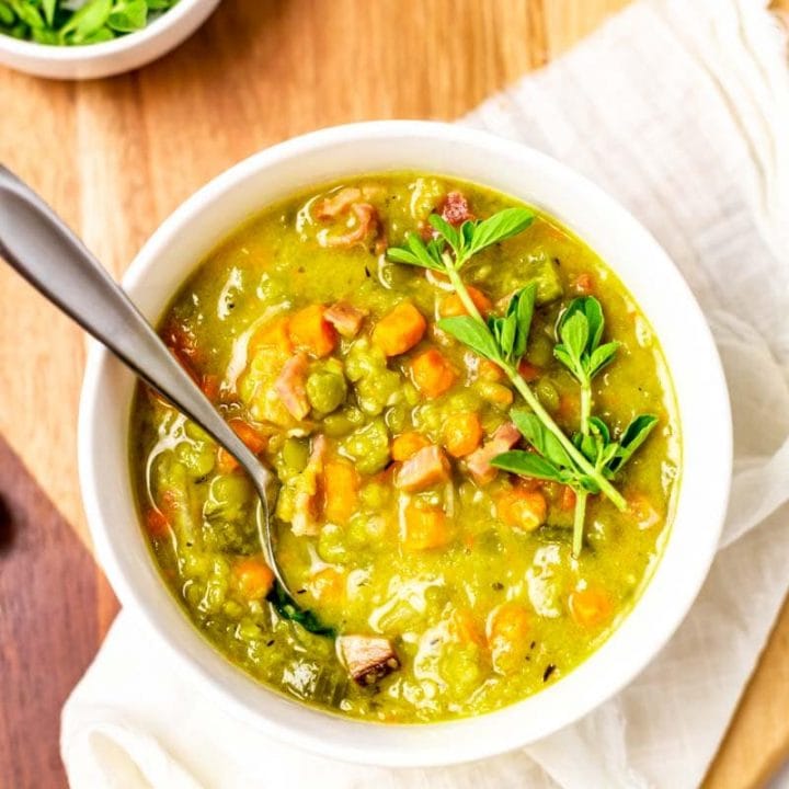 Overhead of split pea and ham soup in a bowl with a spoon in it.