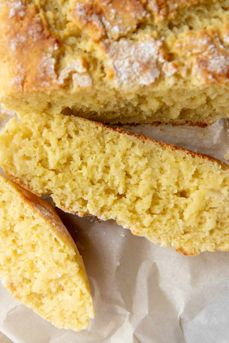 Close view of the tender crumb inside a slice of gluten-free bread made with almond flour.