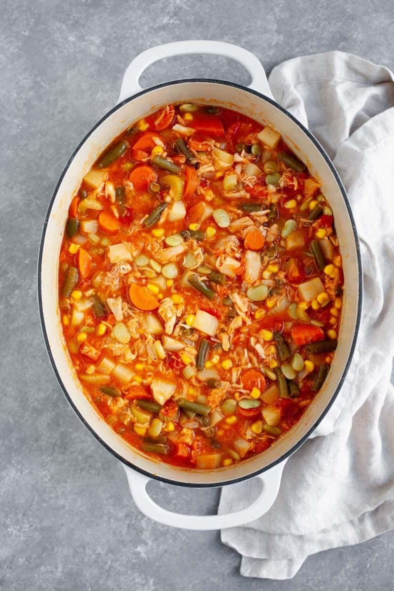 Turkey Vegetable Soup in a stockpot on a marbled background