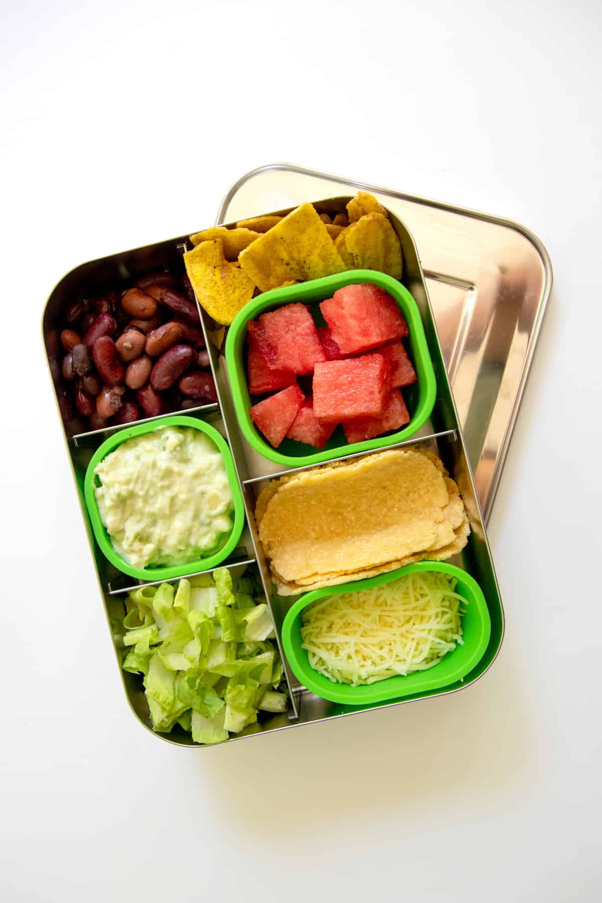 Bento-style lunch box filled with the makings for two-bite tacos