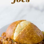 Vegetarian Lentil Sloppy Joe sits on a white plate. A text overlay reads "Vegetarian Lentil Sloppy Joes".