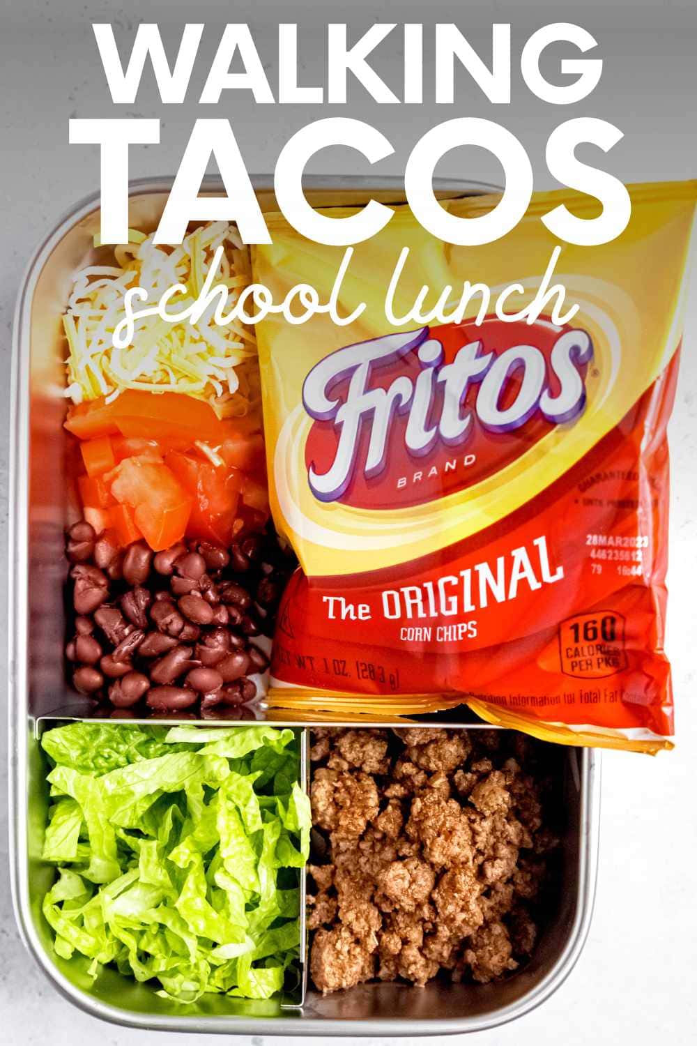 Overhead of a deconstructed taco lunch in a bento-style lunch box. A text overlay reads, "Walking Tacos School Lunch."