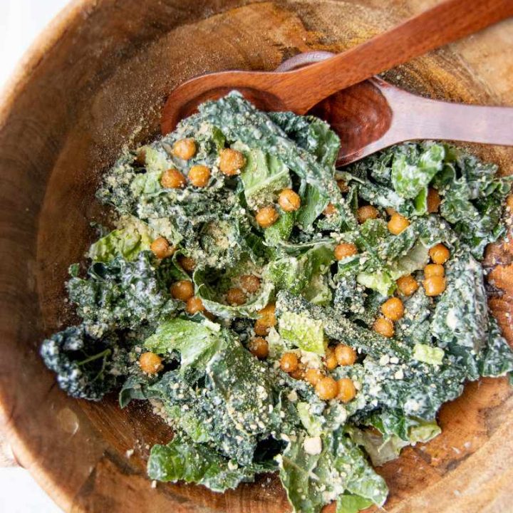 Close view kale caesar salad with crunchy chickpea croutons and hemp seed parmesan.